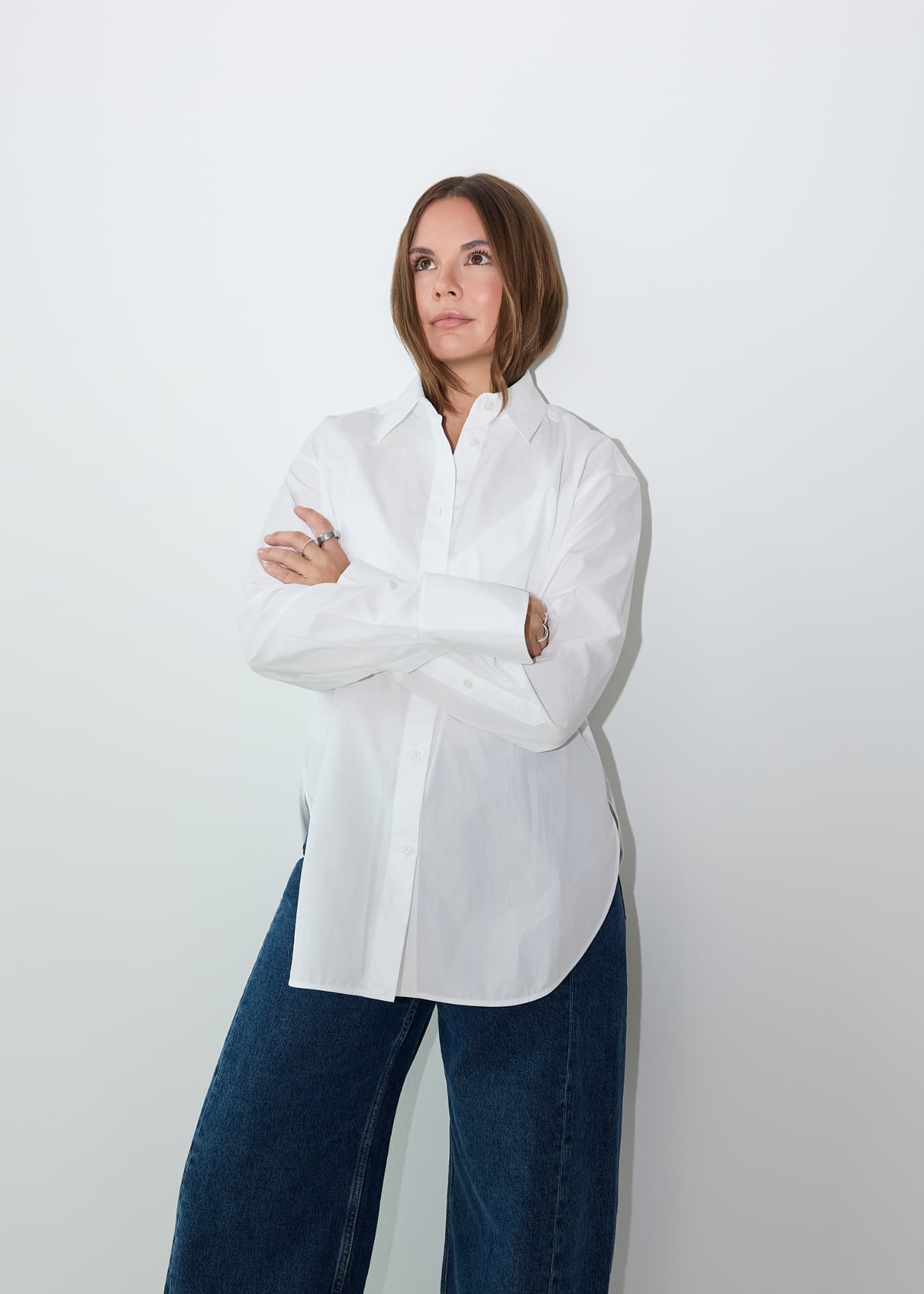 Dajana Mars in a white shirt, arms folded